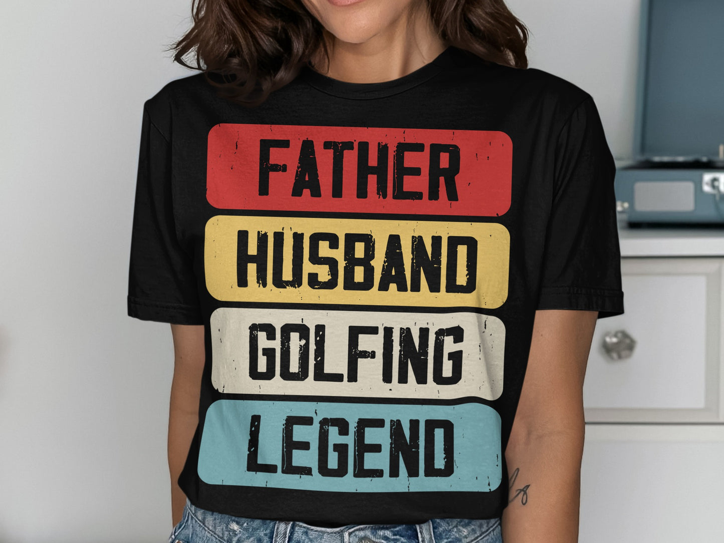 Black t-shirt with "FATHER HUSBAND GOLFING LEGEND" in colorful block letters.