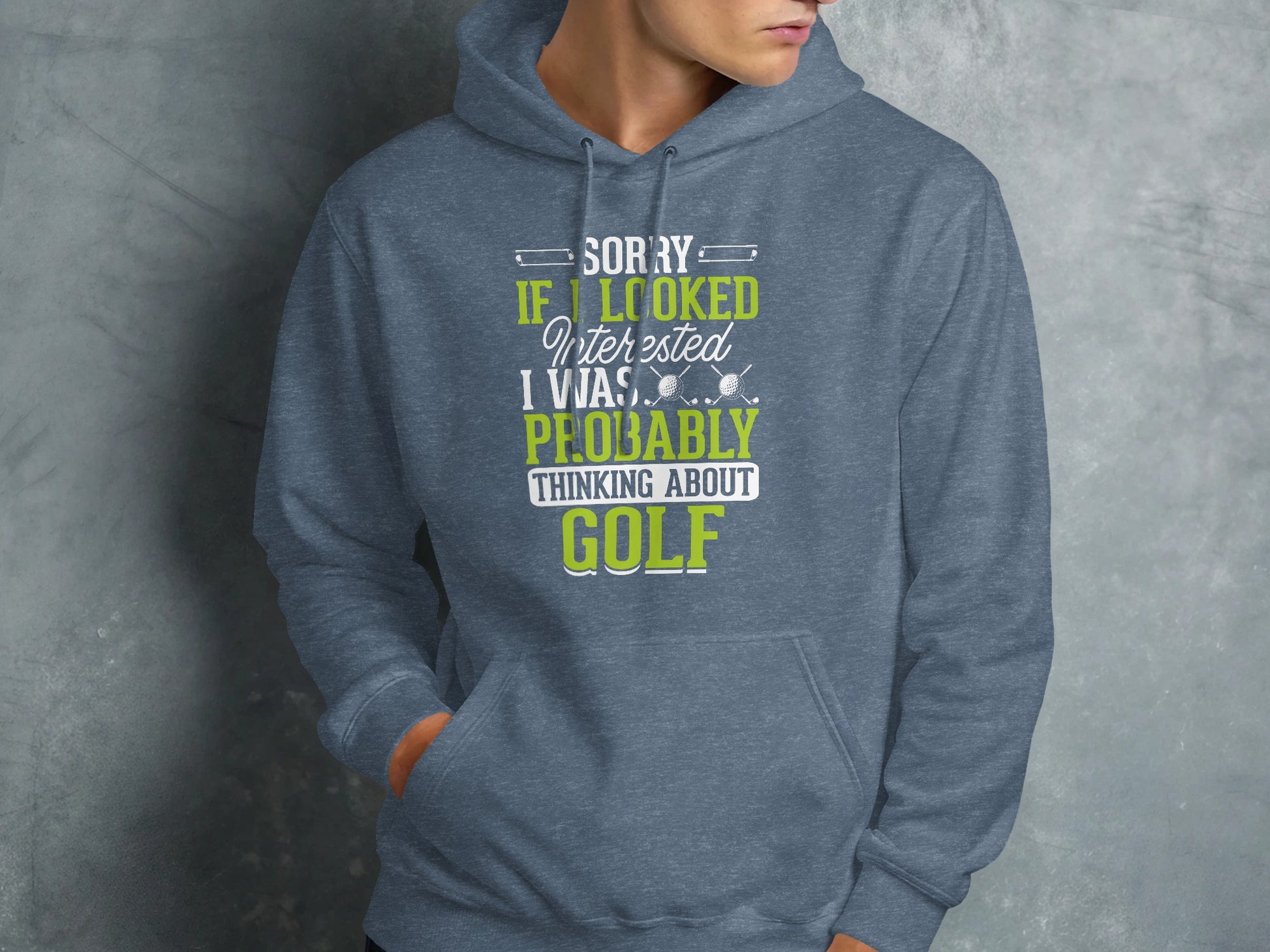 Grey hooded sweatshirt with "Sorry if I looked interested I was probably thinking about golf" text.