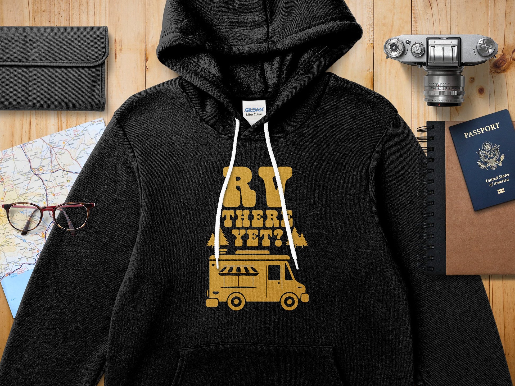 Black hoodie with "RV THERE YET?" text and a vintage camper graphic.