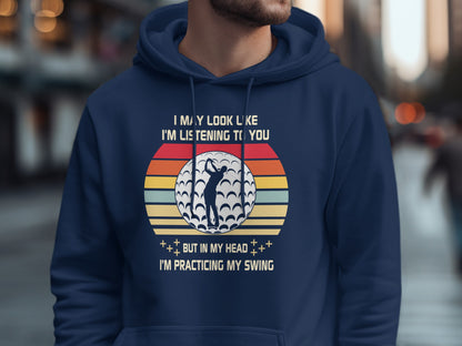 Men's hoodie with "Practicing My Swing" golf graphic.