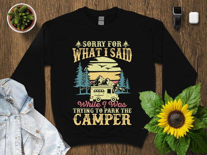 Black sweatshirt with "Sorry for what I said while trying to park the camper" text and graphic.