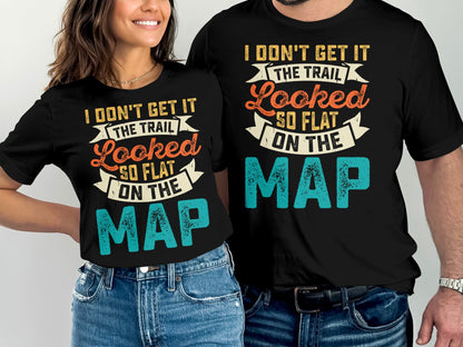 Couple wearing black t-shirts with "I Don't Get It The Trail Looked So Flat On The Map" text.
