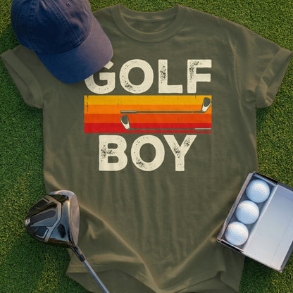 Olive green t-shirt with "GOLF BOY" text and golf clubs above a sunset stripe.