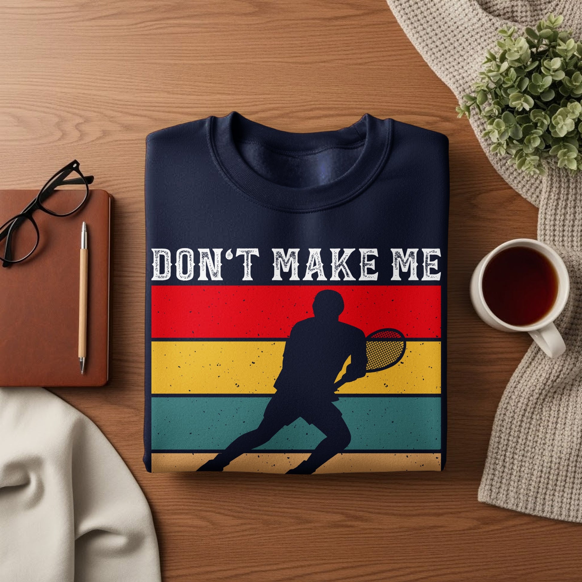 Navy sweatshirt with a tennis player graphic and "DON'T MAKE ME" text.
