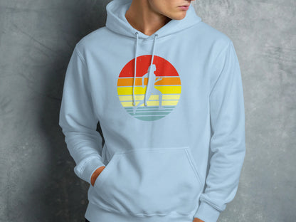 Light blue hoodie with a circular graphic of a runner against a sunset.