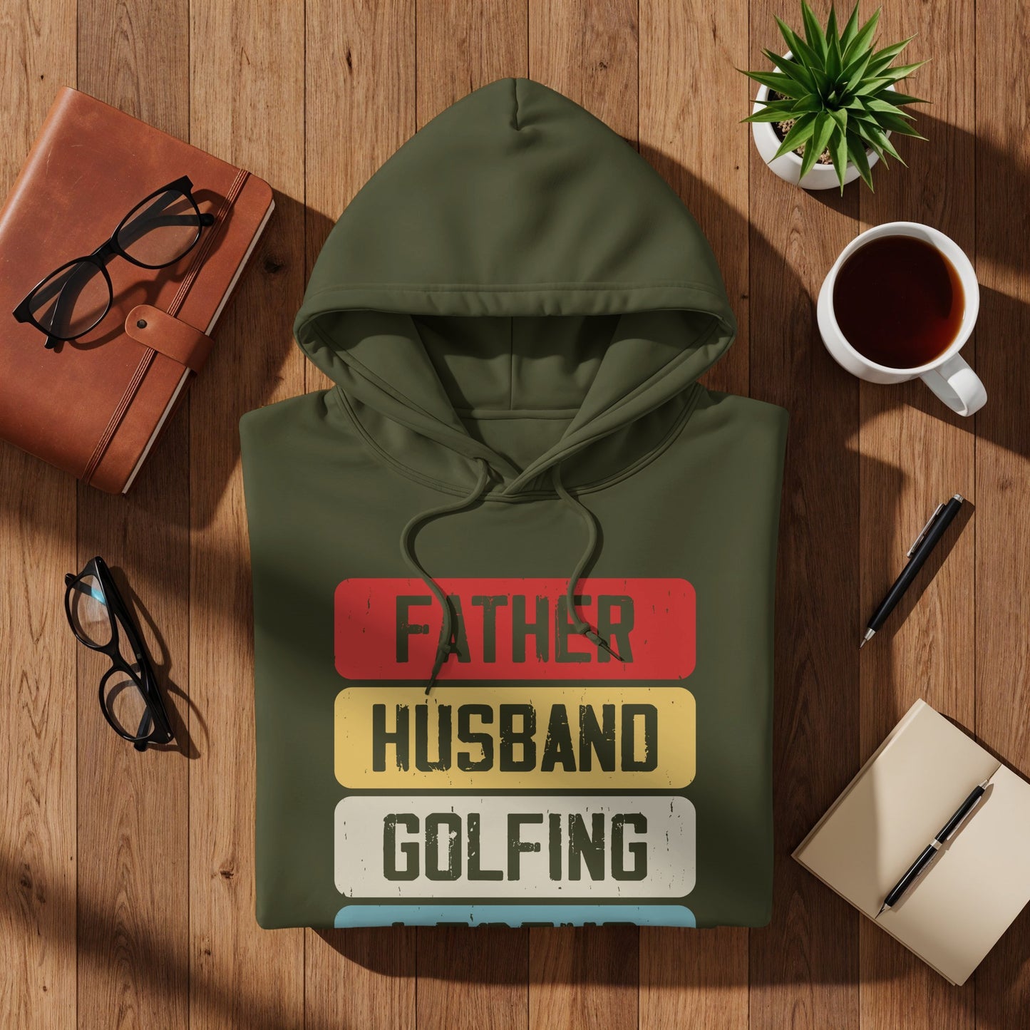 Green hoodie with "Father Husband Golfing" text in red, yellow, and white stripes.