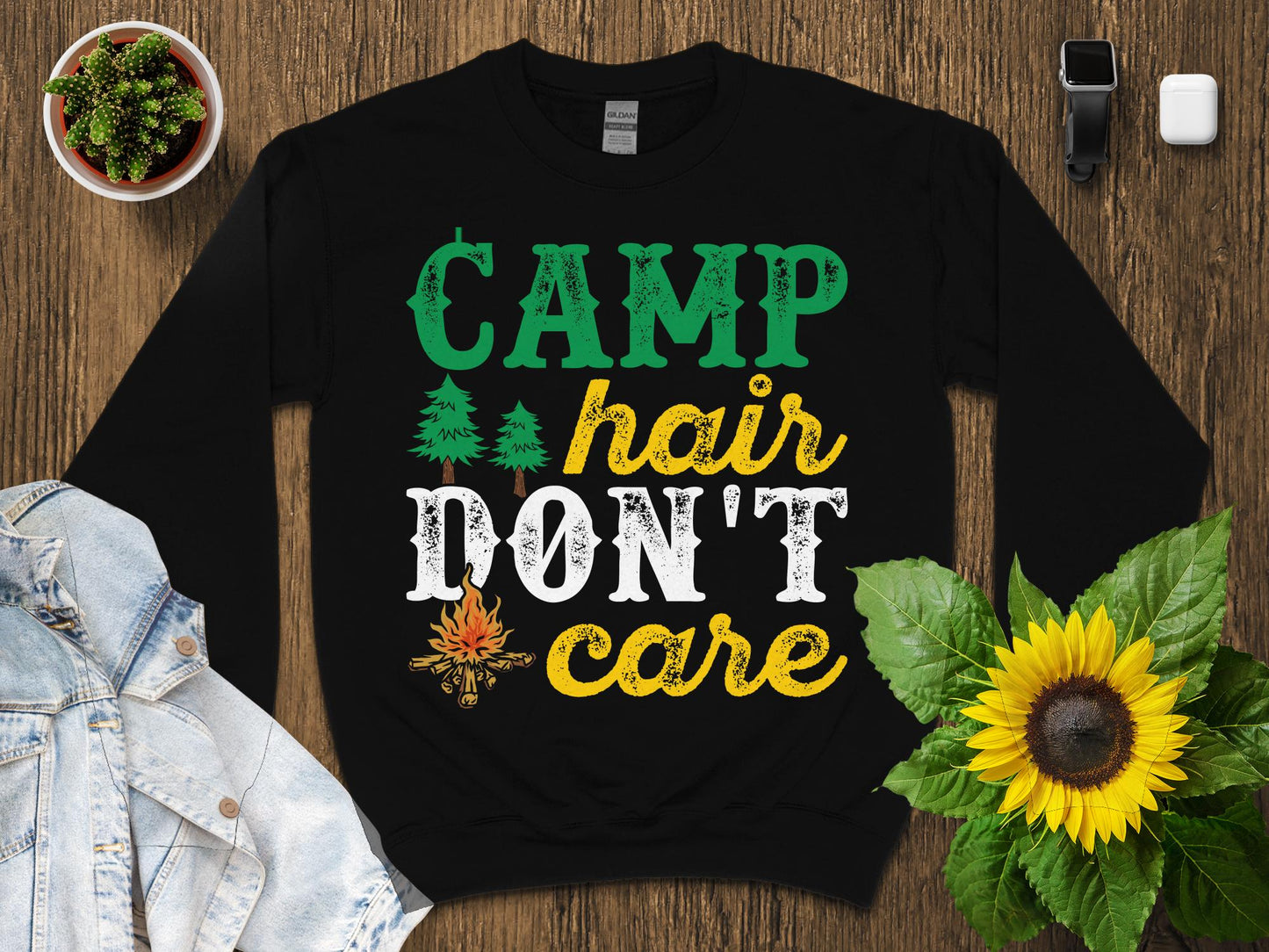 Black sweatshirt with "CAMP hair DON'T care" text, campfire, and trees graphic.