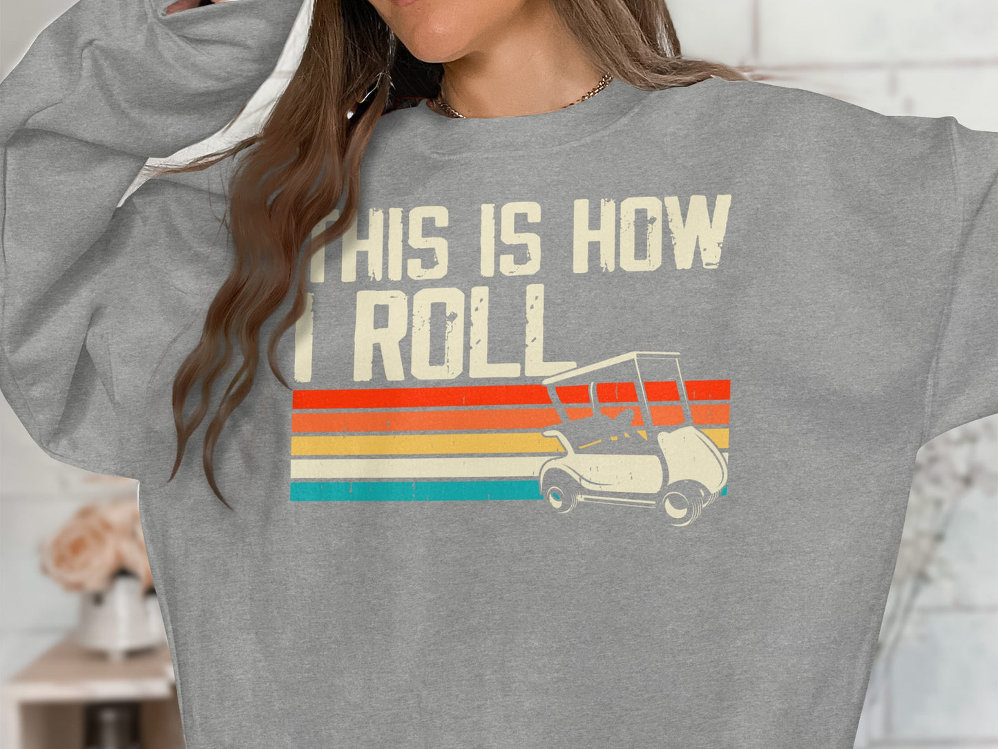 Gray sweatshirt with "THIS IS HOW I ROLL" and a vintage golf cart graphic.