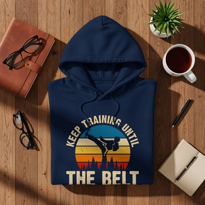 Navy hoodie with "Keep training until the belt" text and martial arts graphic.