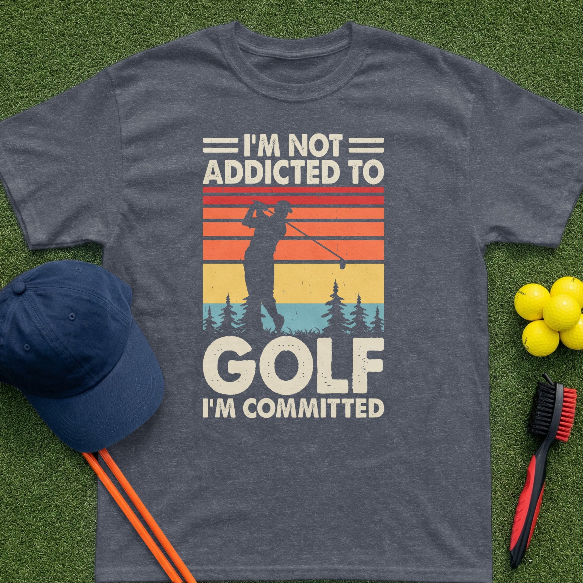 T-shirt with text "I'm Not Addicted To Golf, I'm Committed" and golf imagery.