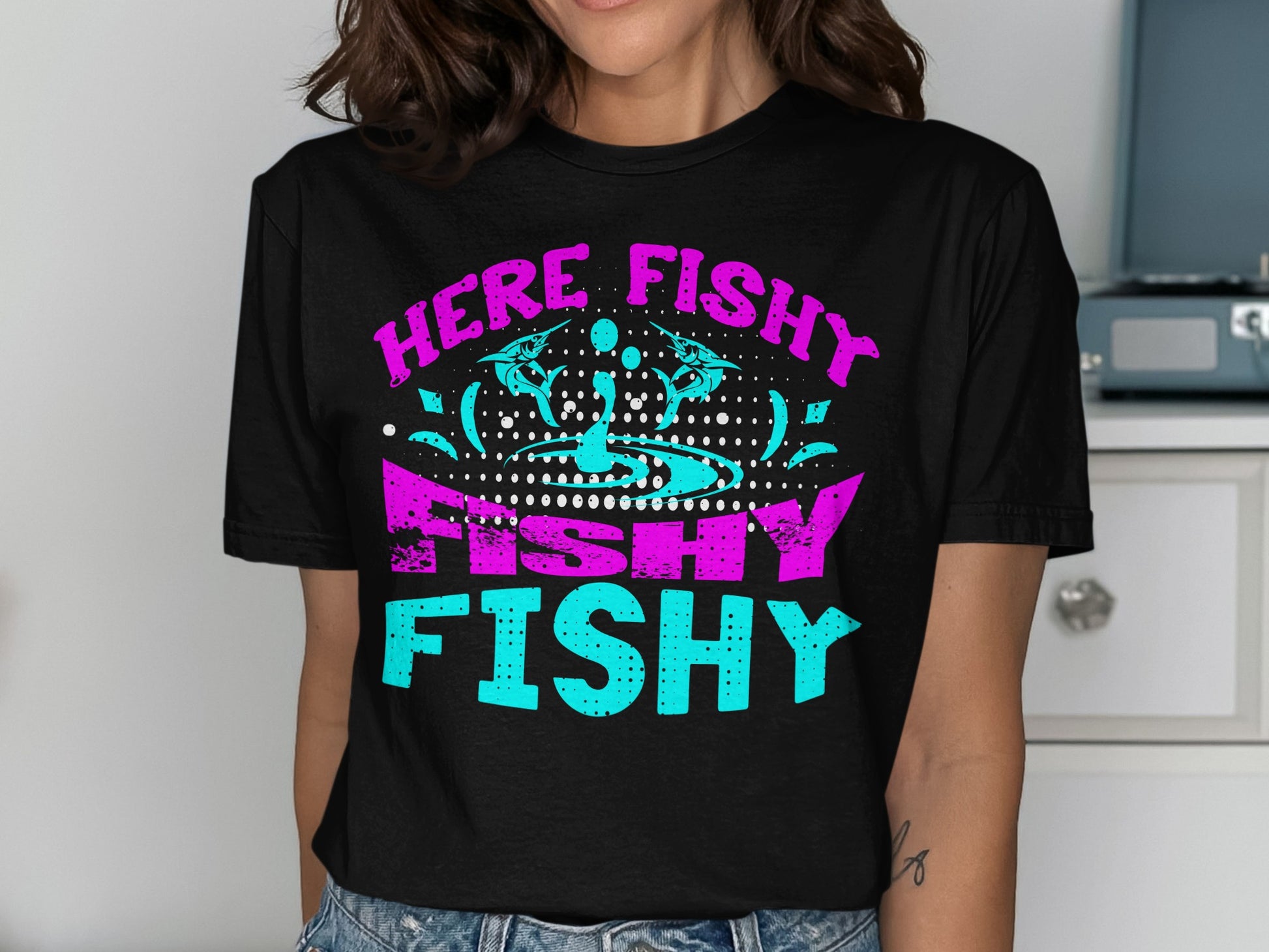 Black t-shirt with "HERE FISHY FISHY FISHY" text and abstract fish graphic.