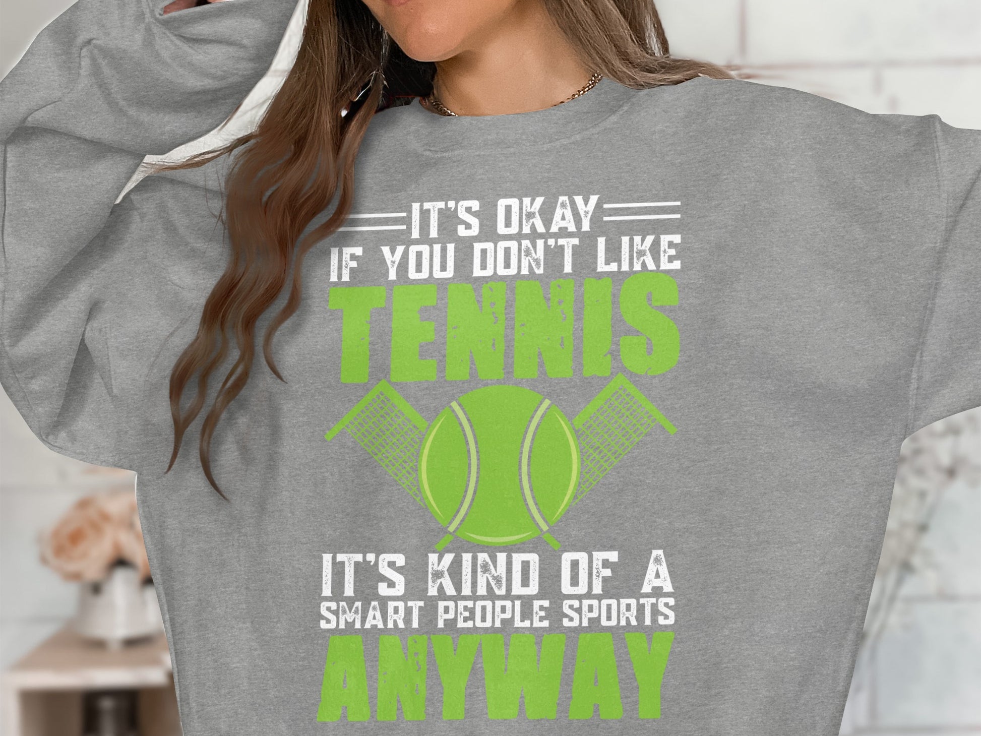 Grey sweatshirt with "It's okay if you don't like tennis. It's kind of a smart people sport anyway."
