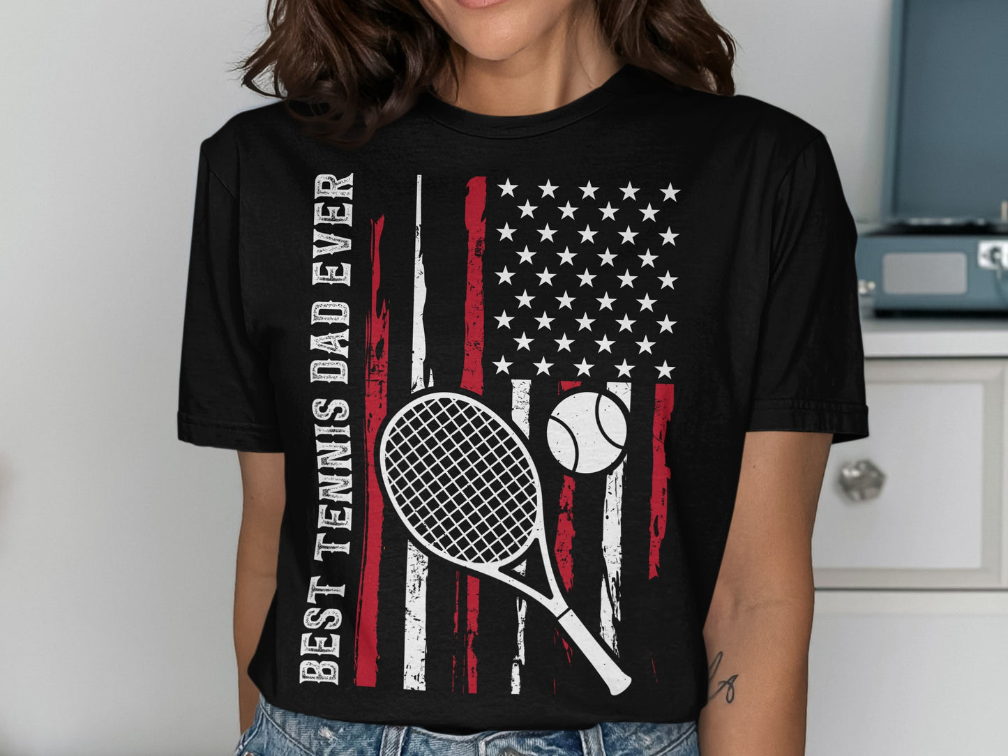 T-shirt with American flag, tennis racket, ball, and text.