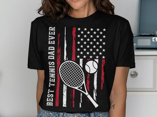 T-shirt with American flag, tennis racket, ball, and text.