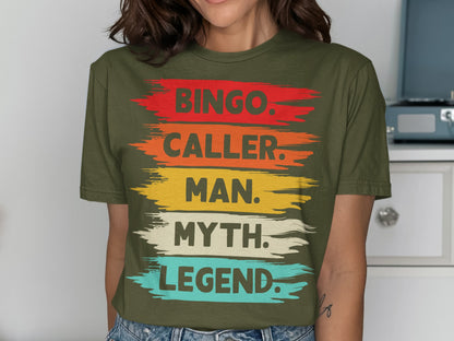 Olive green t-shirt with "Bingo. Caller. Man. Myth. Legend." text in colorful brush strokes.
