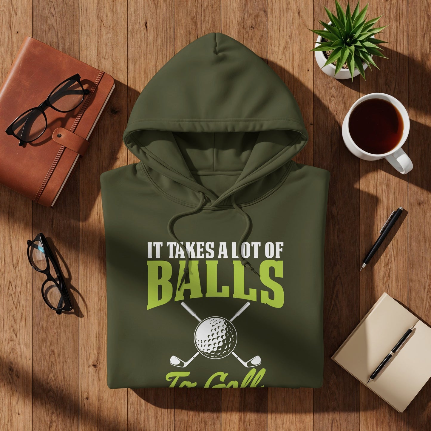 Green hoodie with "It takes a lot of BALLS To Golf" text and golf club graphic.