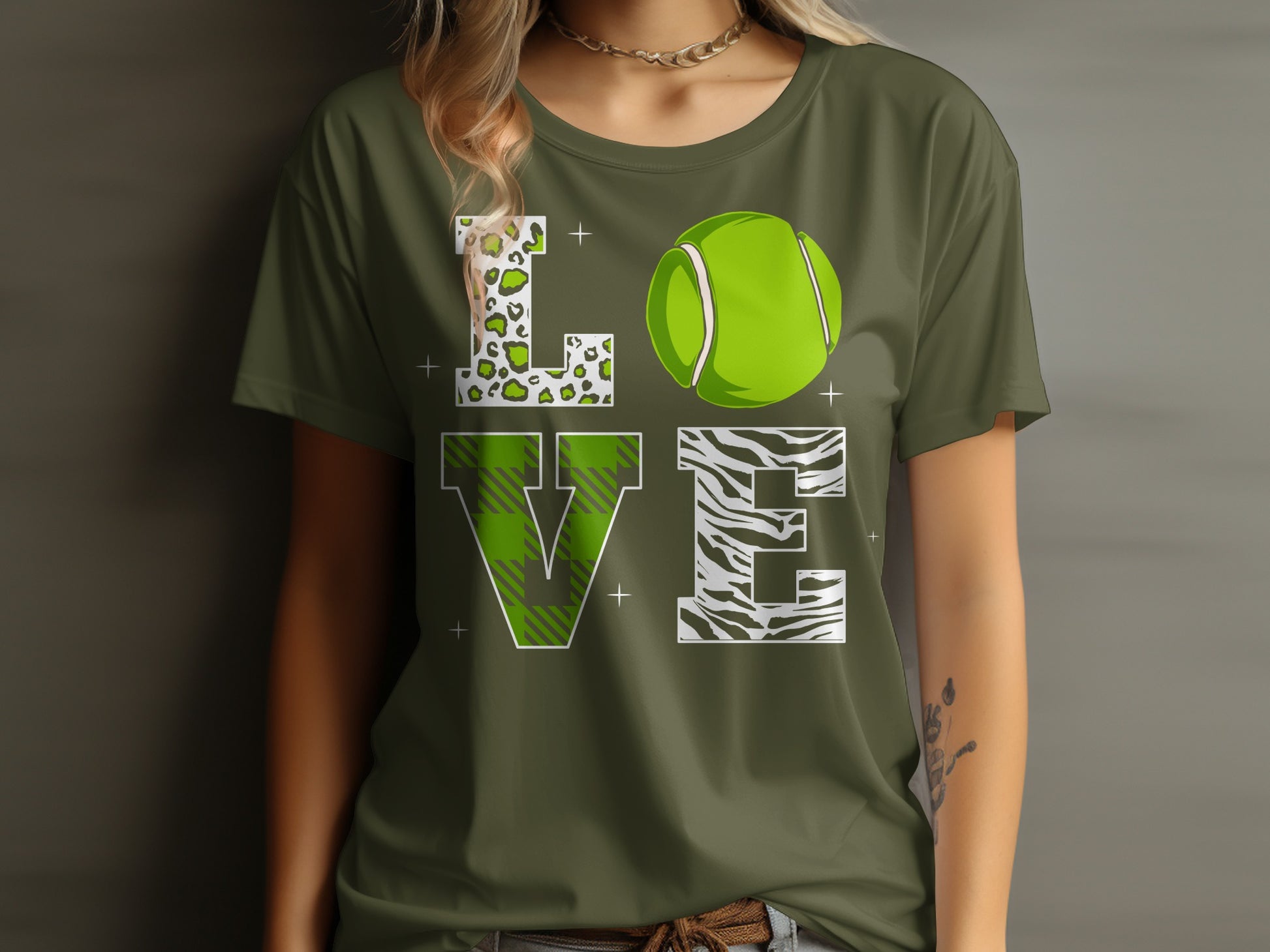 Green t-shirt with "LOVE" design featuring tennis ball and animal prints.