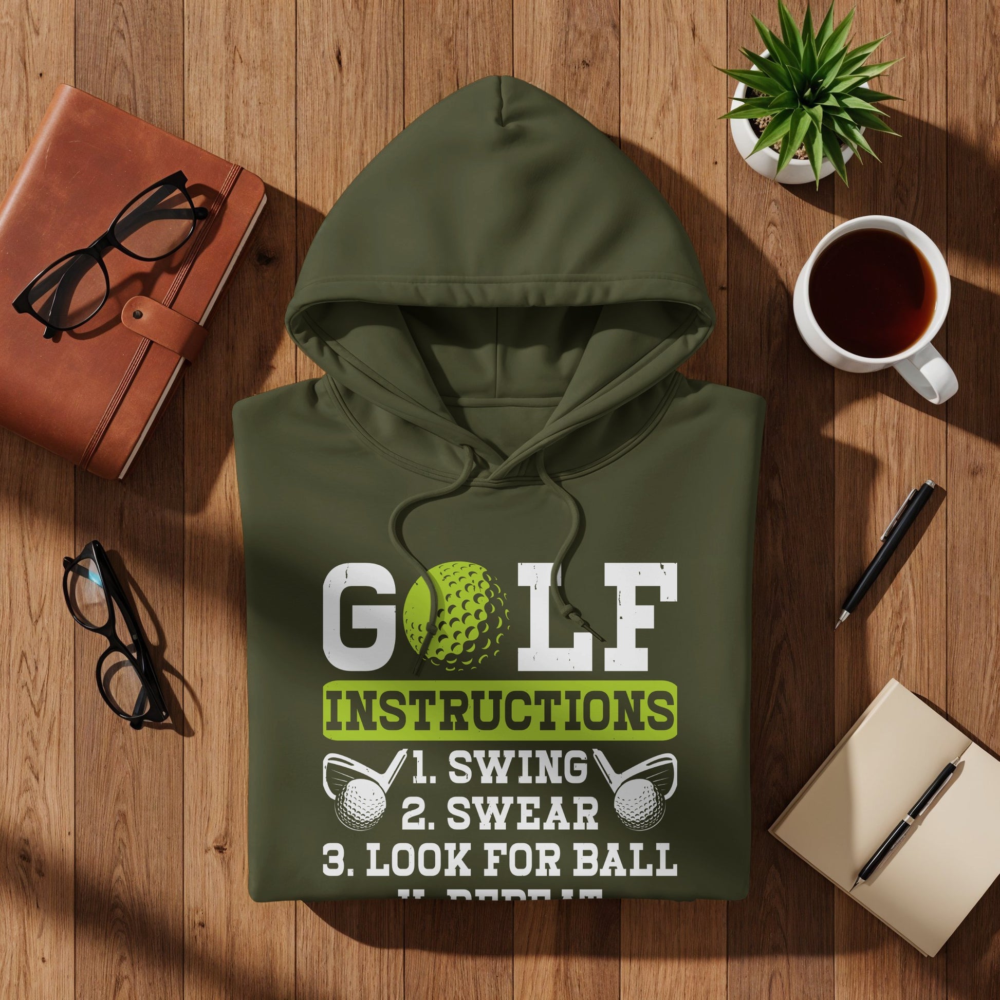 Olive green hoodie with "GOLF INSTRUCTIONS 1. SWING 2. SWEAR 3. LOOK FOR BALL" text.