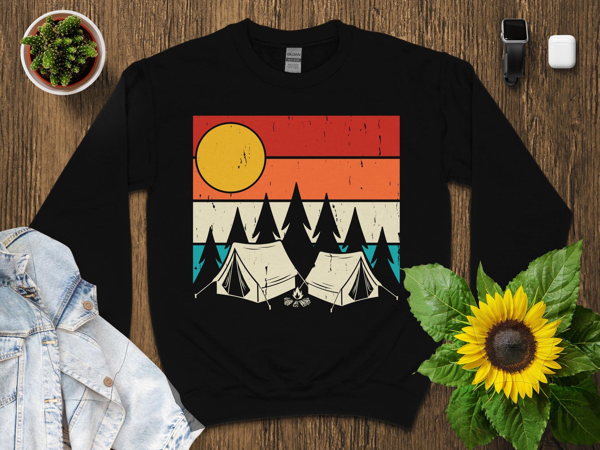 Retro sunset with two tents and pine trees graphic on black crewneck sweatshirt.