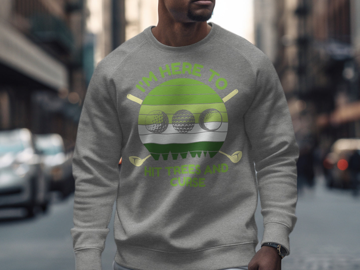 Gray sweatshirt with green circular graphic "I'm Here to Hit Golf Balls."