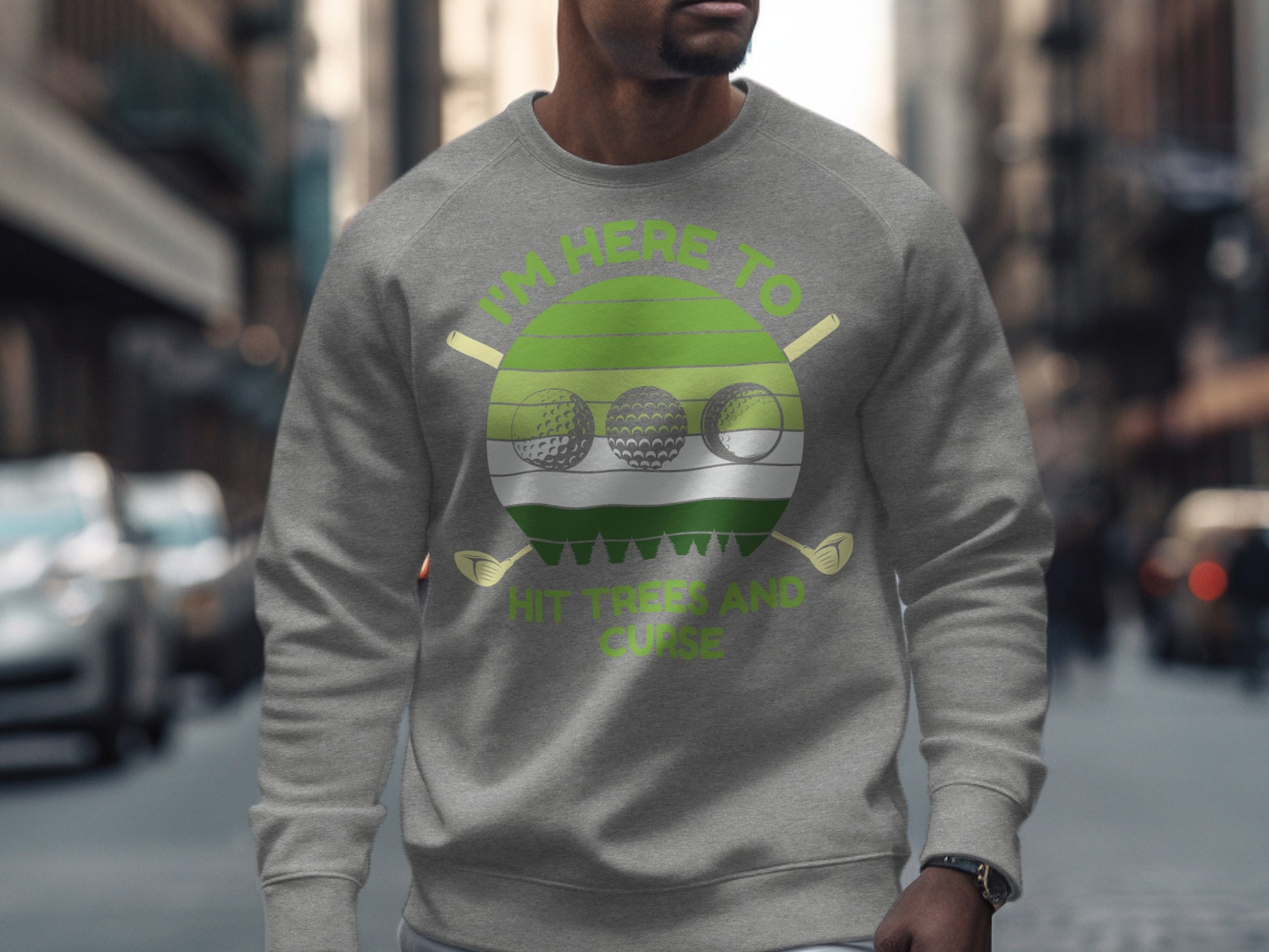 Gray sweatshirt with green circular graphic "I'm Here to Hit Golf Balls."