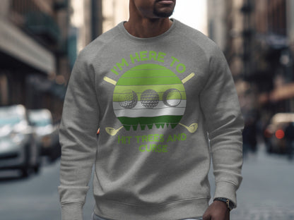Gray sweatshirt with green circular graphic "I'm Here to Hit Golf Balls."