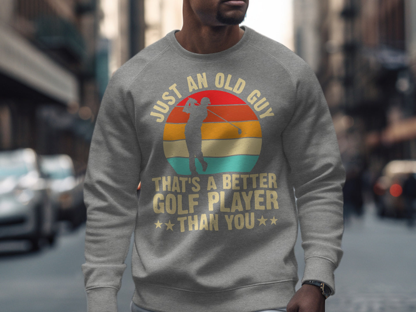 Gray sweatshirt with "Just an old guy, that's a better golfer than you" text and golfer graphic.