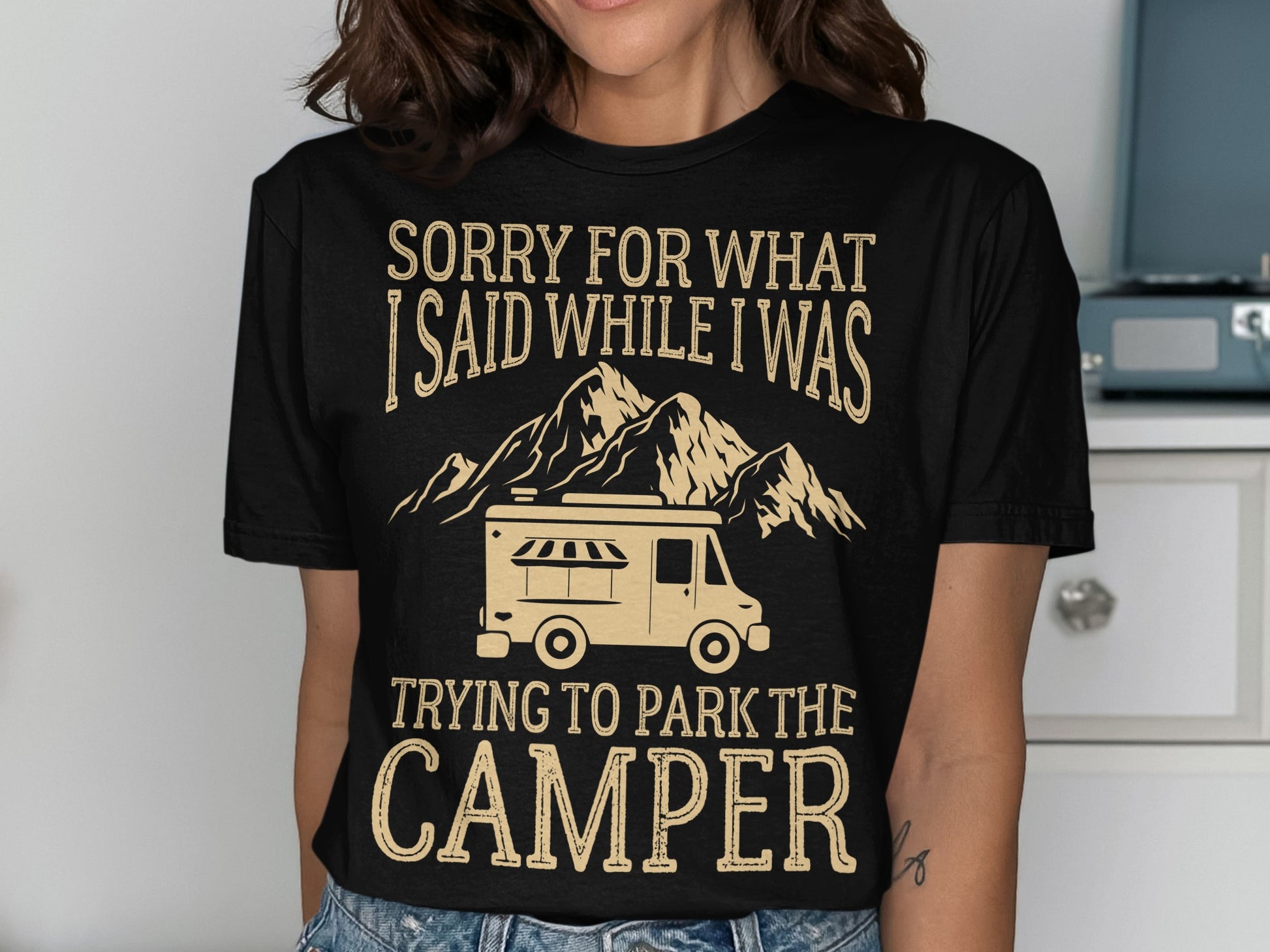 Black t-shirt with text and camper graphic.