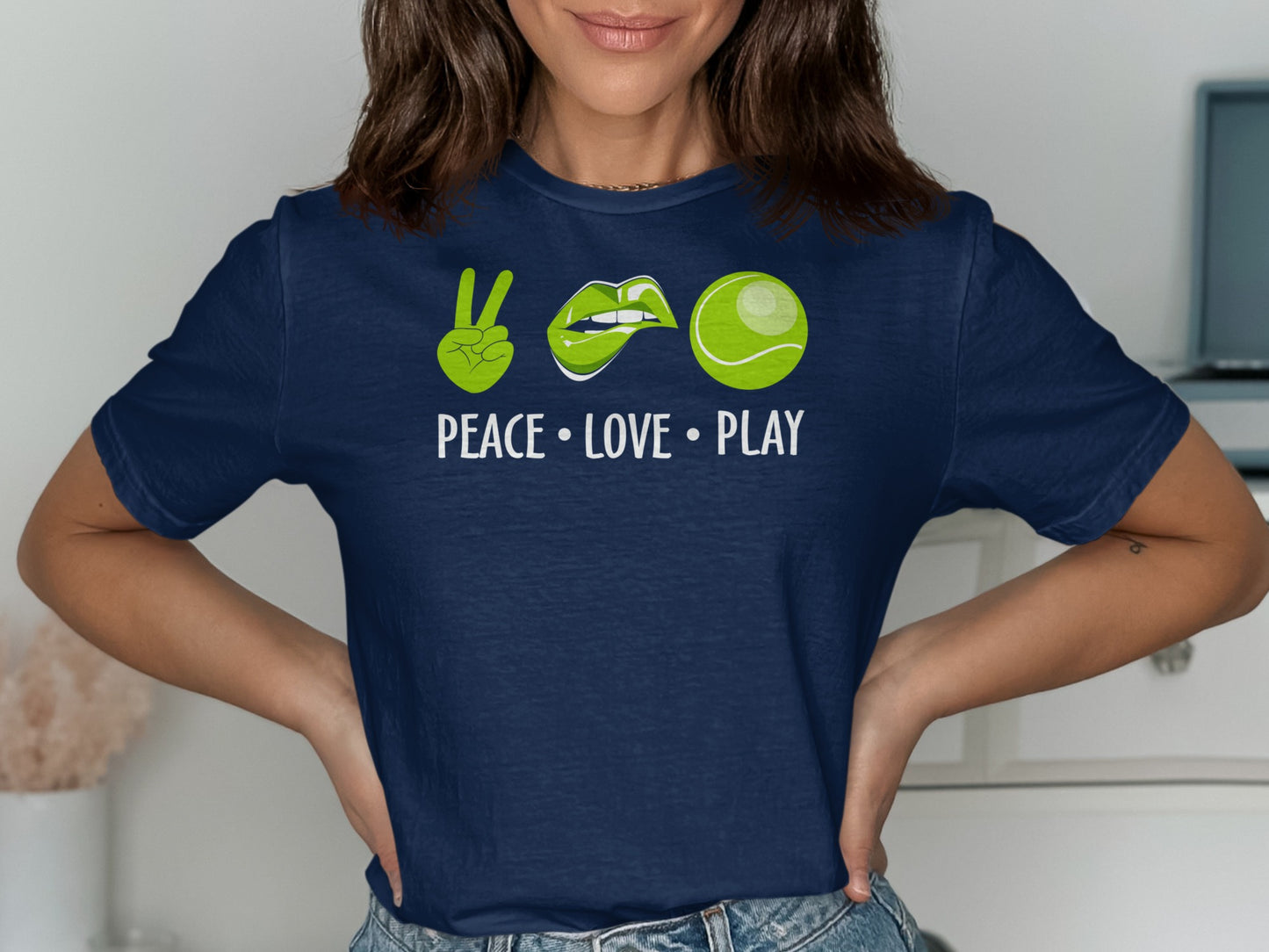 Navy t-shirt with green peace sign, lips, tennis ball, and "PEACE • LOVE • PLAY" text.