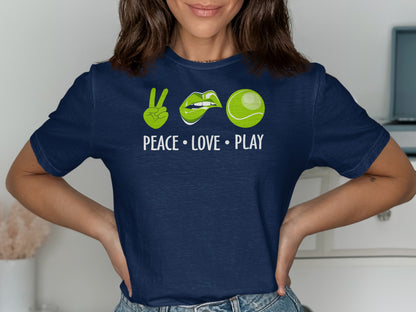 Navy t-shirt with green peace sign, lips, tennis ball, and "PEACE • LOVE • PLAY" text.