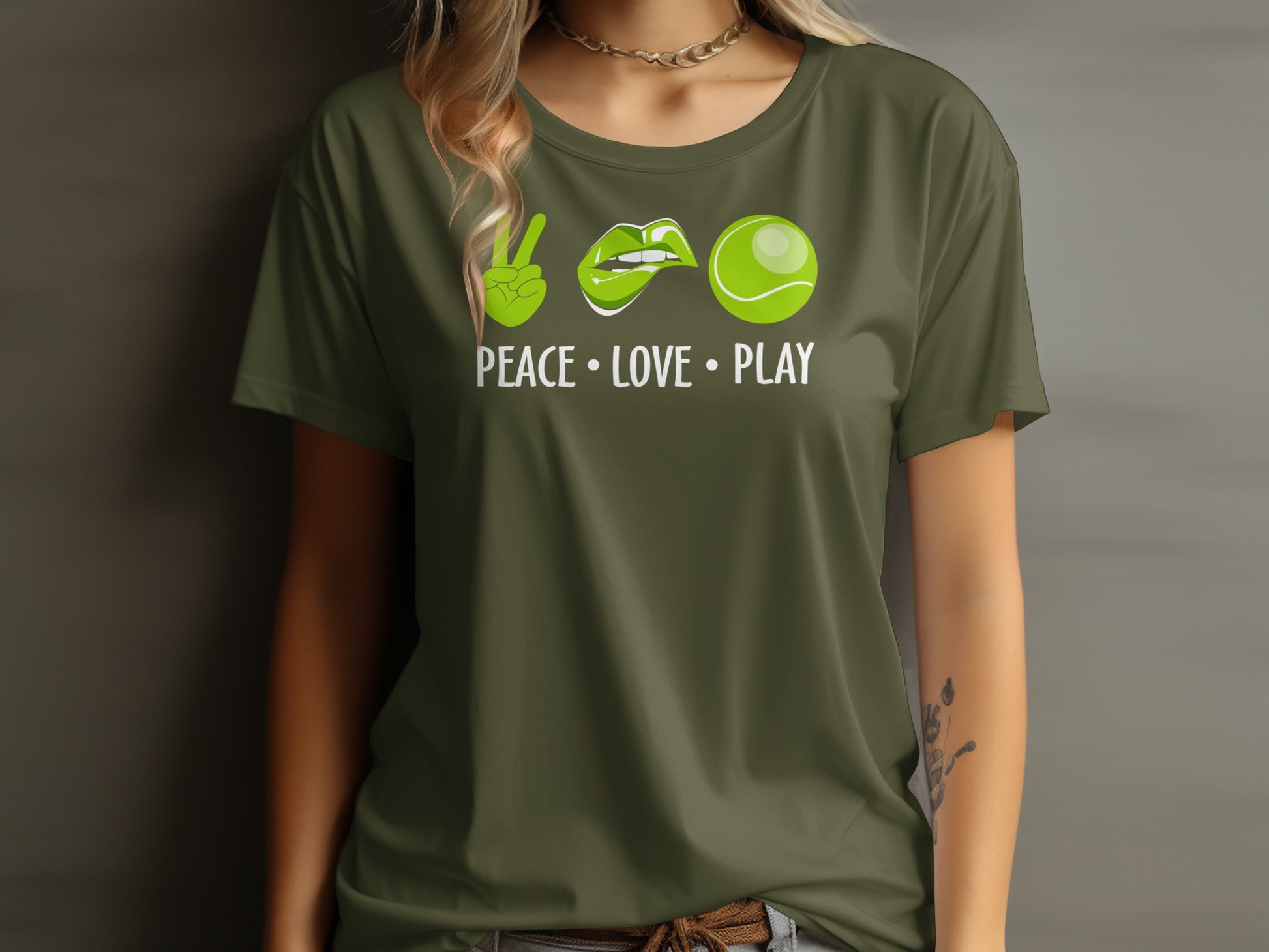Green t-shirt with peace sign, lips, and tennis ball icons and text "PEACE • LOVE • PLAY".