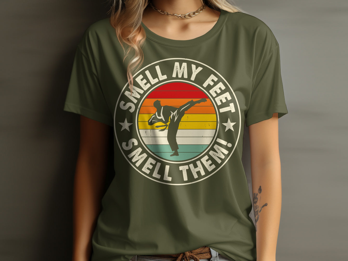 Olive green t-shirt with "Smell My Feet Smell Them!" text and karate fighter graphic.