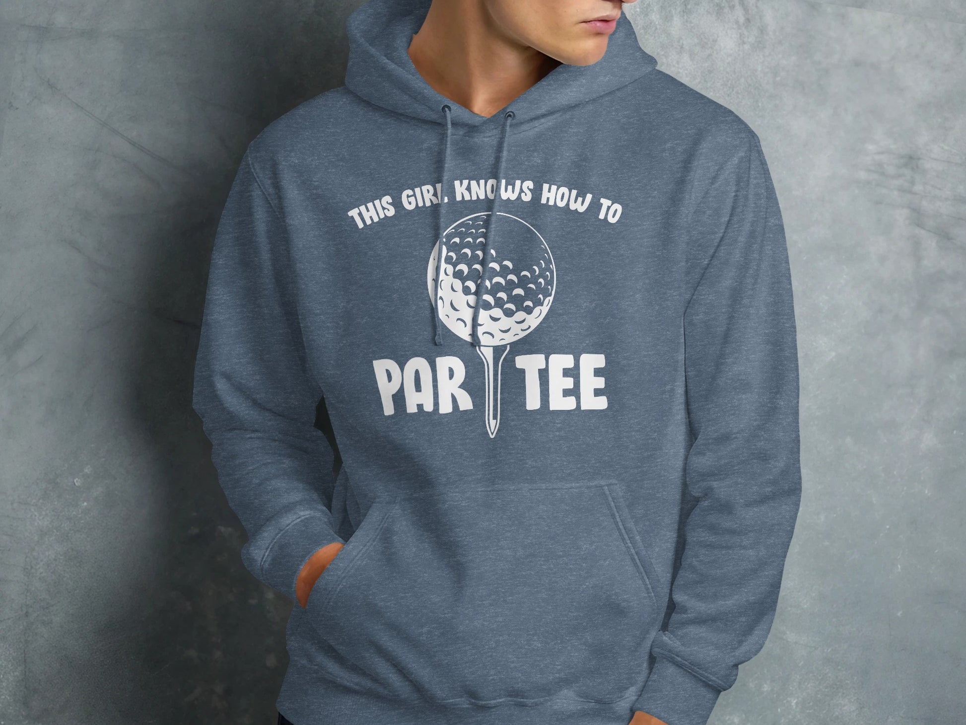 Blue hoodie with golf ball graphic and "This girl knows how to par tee" text.