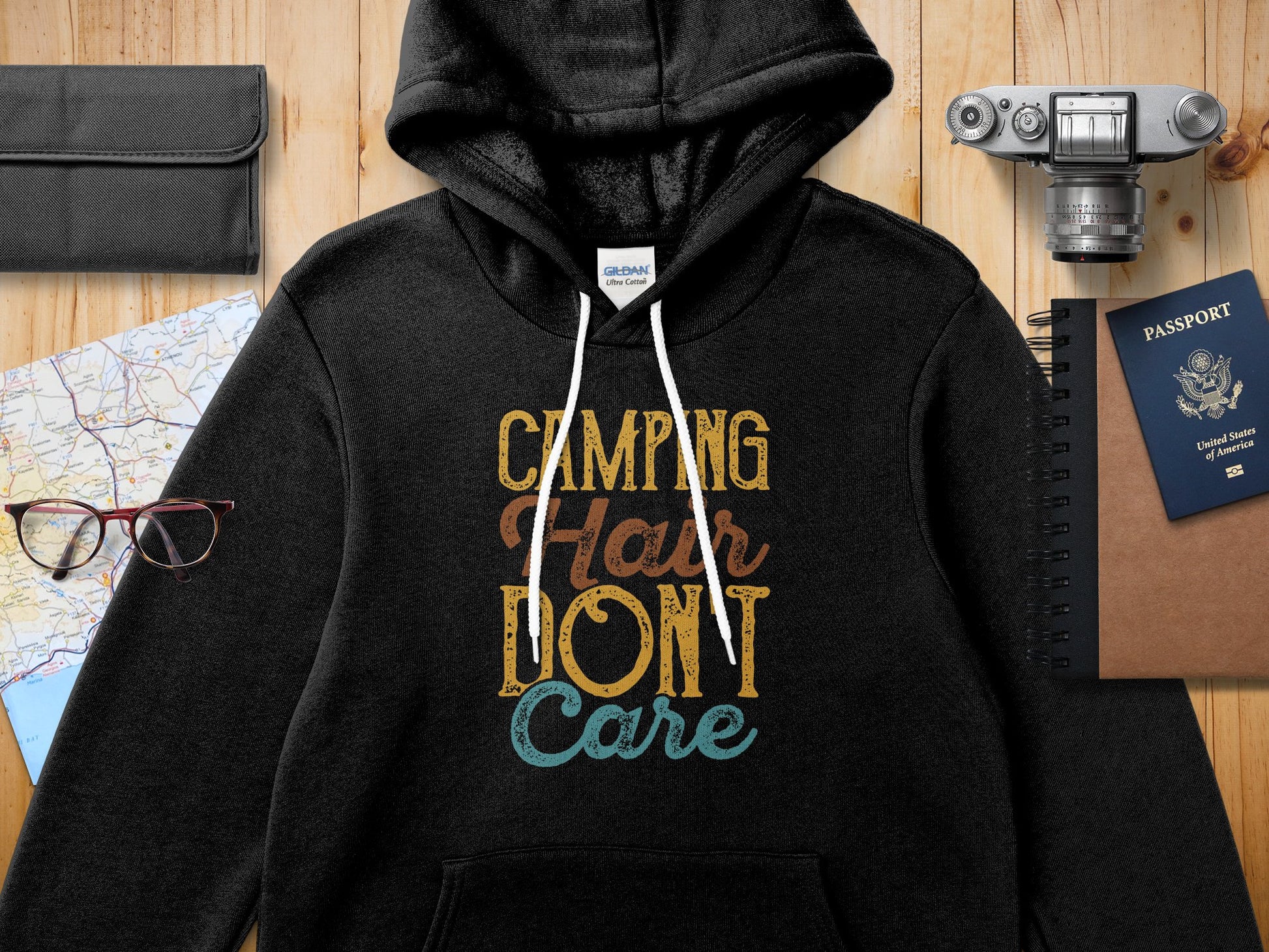 Black Gildan hoodie with "Camping Hair Don't Care" text and graphic.