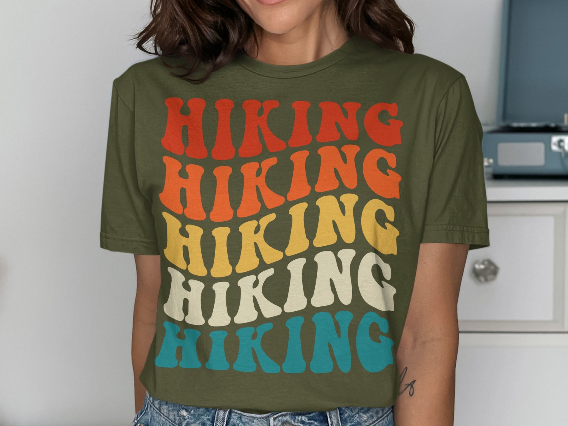 Green t-shirt with "Hiking" in retro striped lettering.