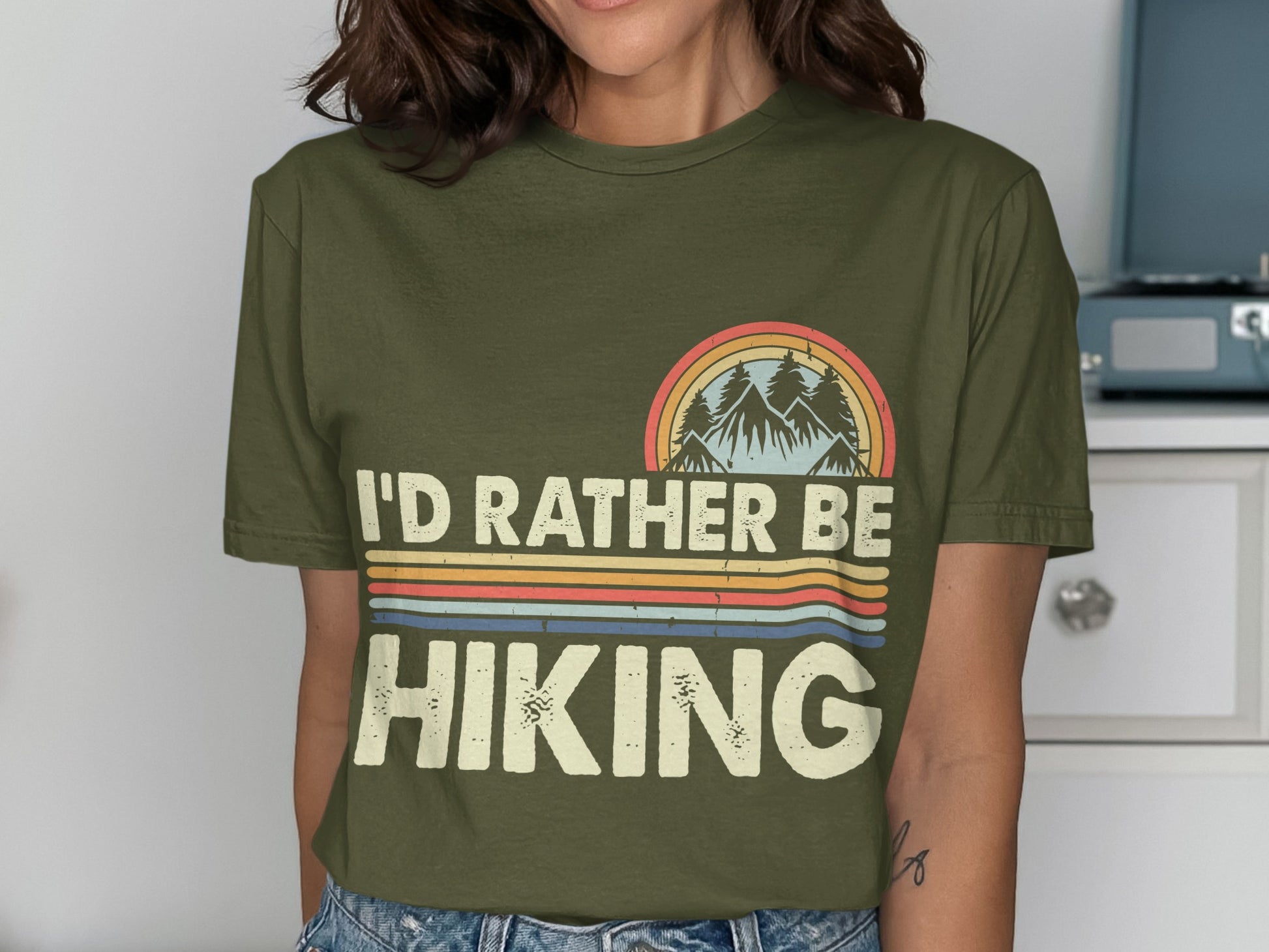 Olive green t-shirt with "I'd Rather Be Hiking" text and retro mountain graphic.