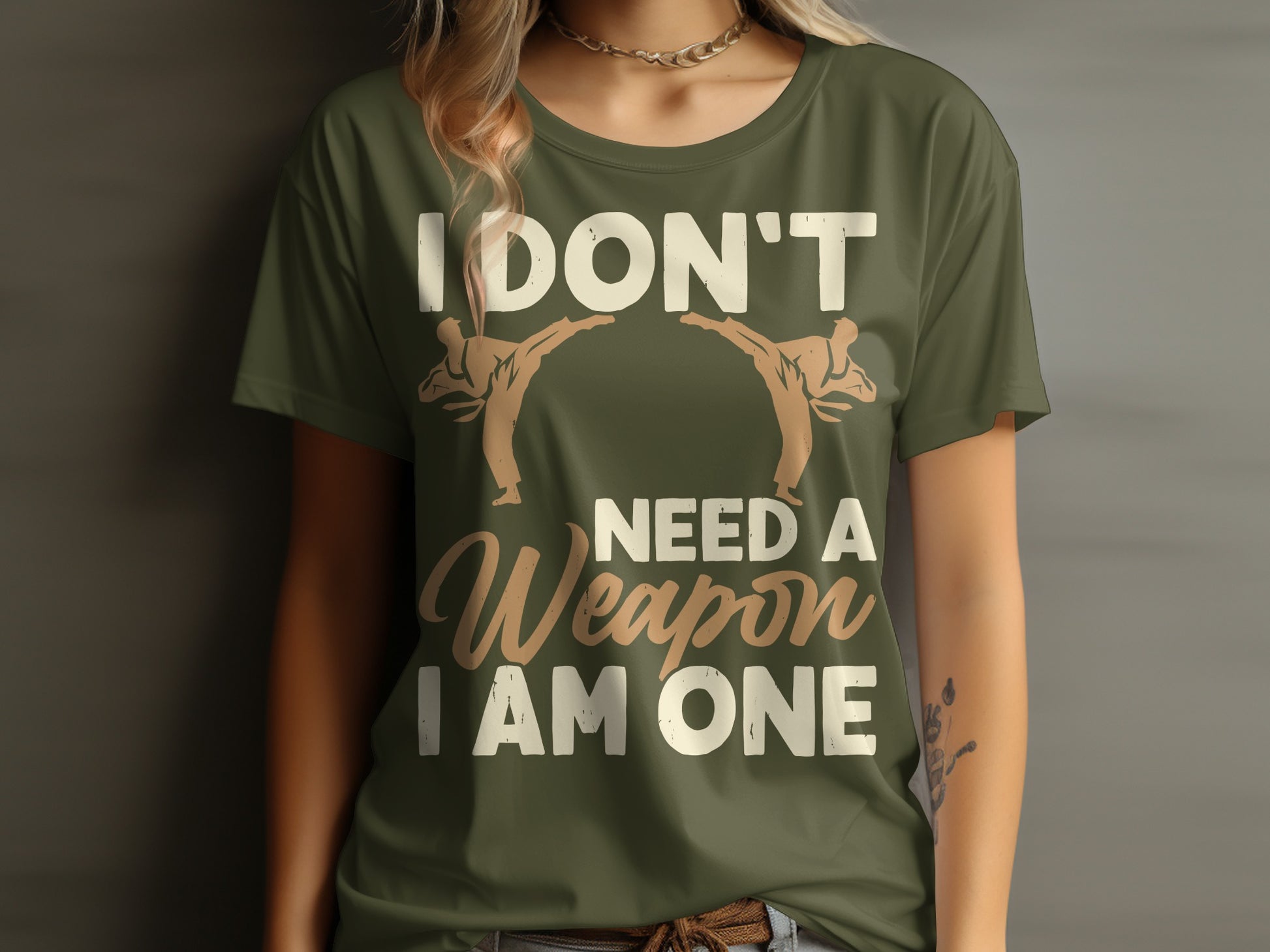 T-shirt with "I DON'T NEED A WEAPON I AM ONE" text and two martial artists.