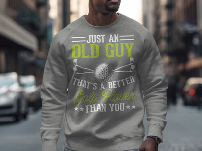 Gray sweatshirt with "Just an old guy that's a better golf player than you" text and golf graphic.