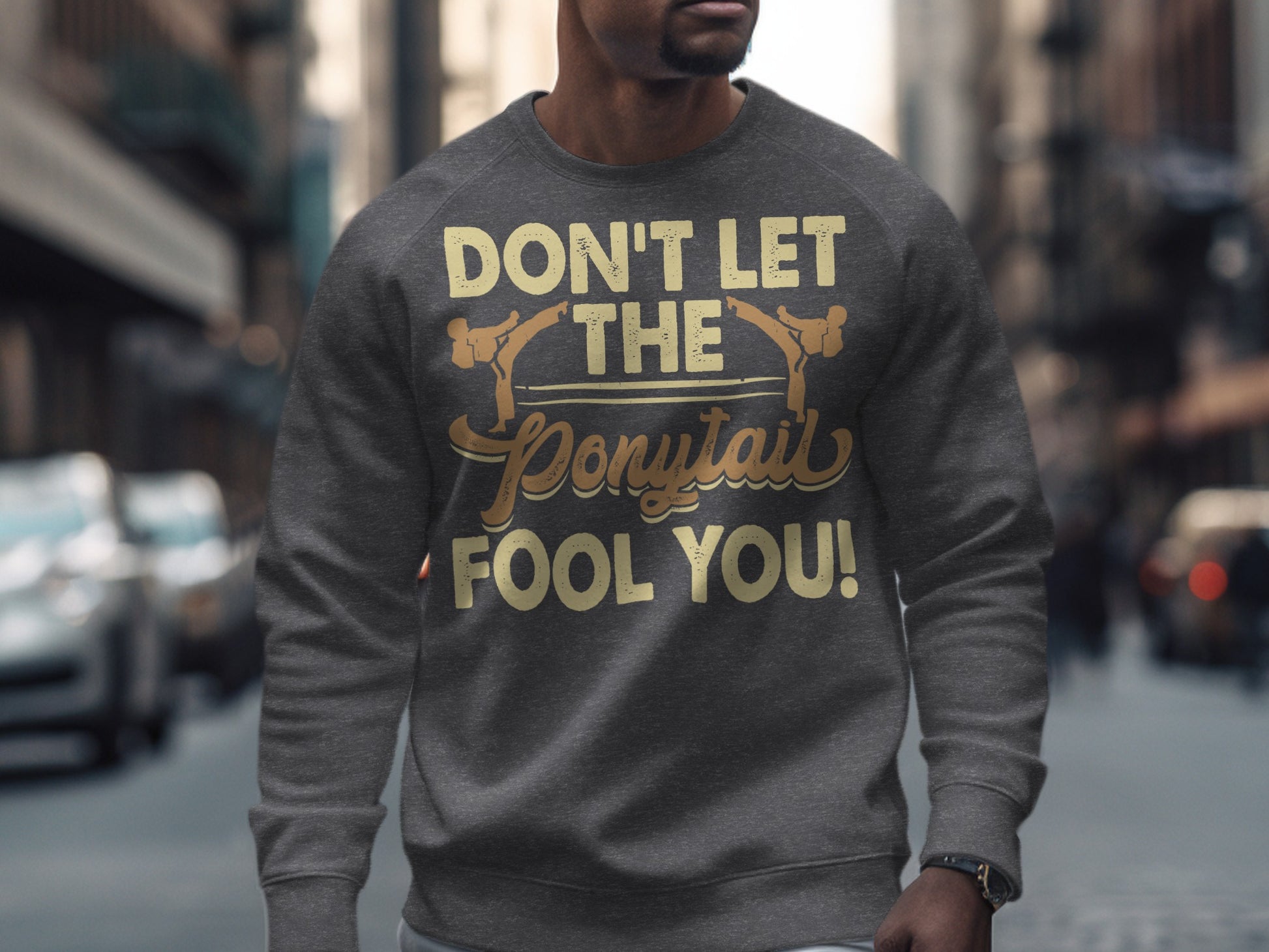 Gray crewneck sweatshirt with "DON'T LET THE PONYTAIL FOOL YOU!" text.