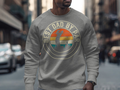 Grey sweatshirt with "Best Dad By Par" text and a golfer in a sunset graphic.