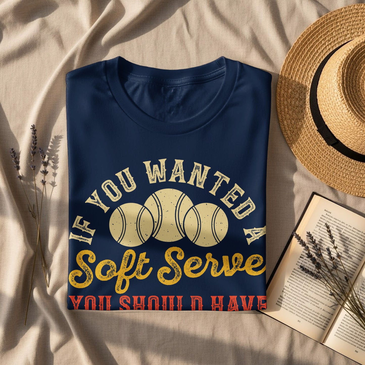 Navy t-shirt with "If you wanted soft serve you should have" text and tennis balls.