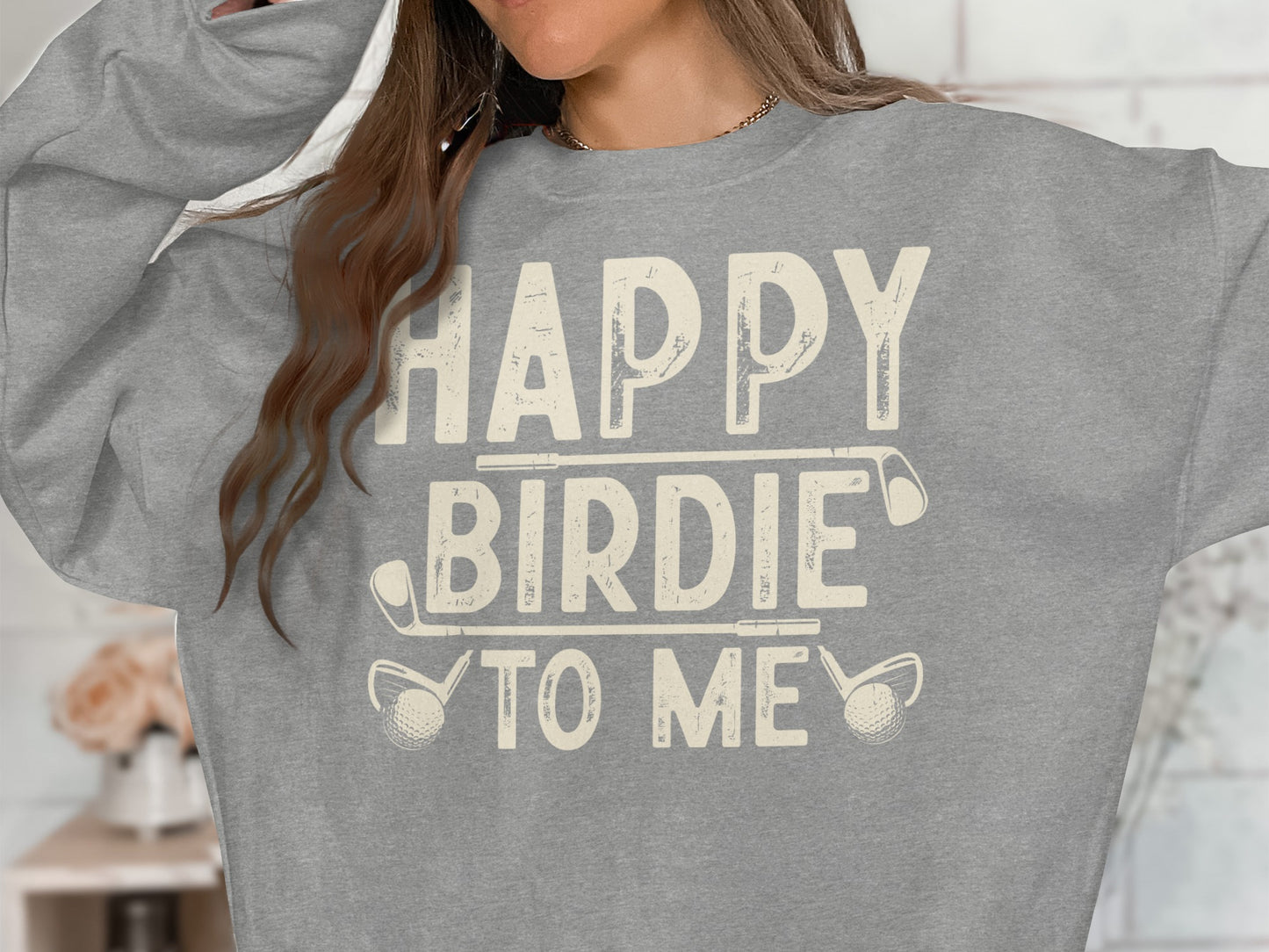 Grey sweatshirt with "Happy Birdie To Me" text and golf club graphics.