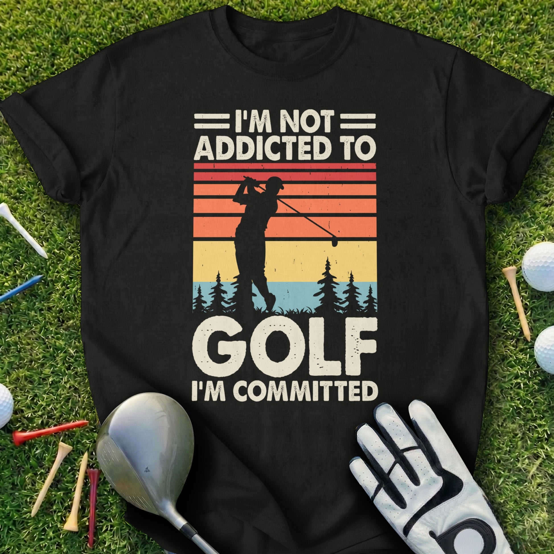 Black t-shirt with "I'm Not Addicted To Golf I'm Committed" and golfer silhouette.