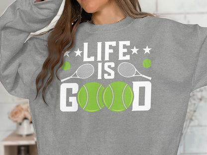 Gray sweatshirt with "LIFE IS GOOD" and tennis balls.