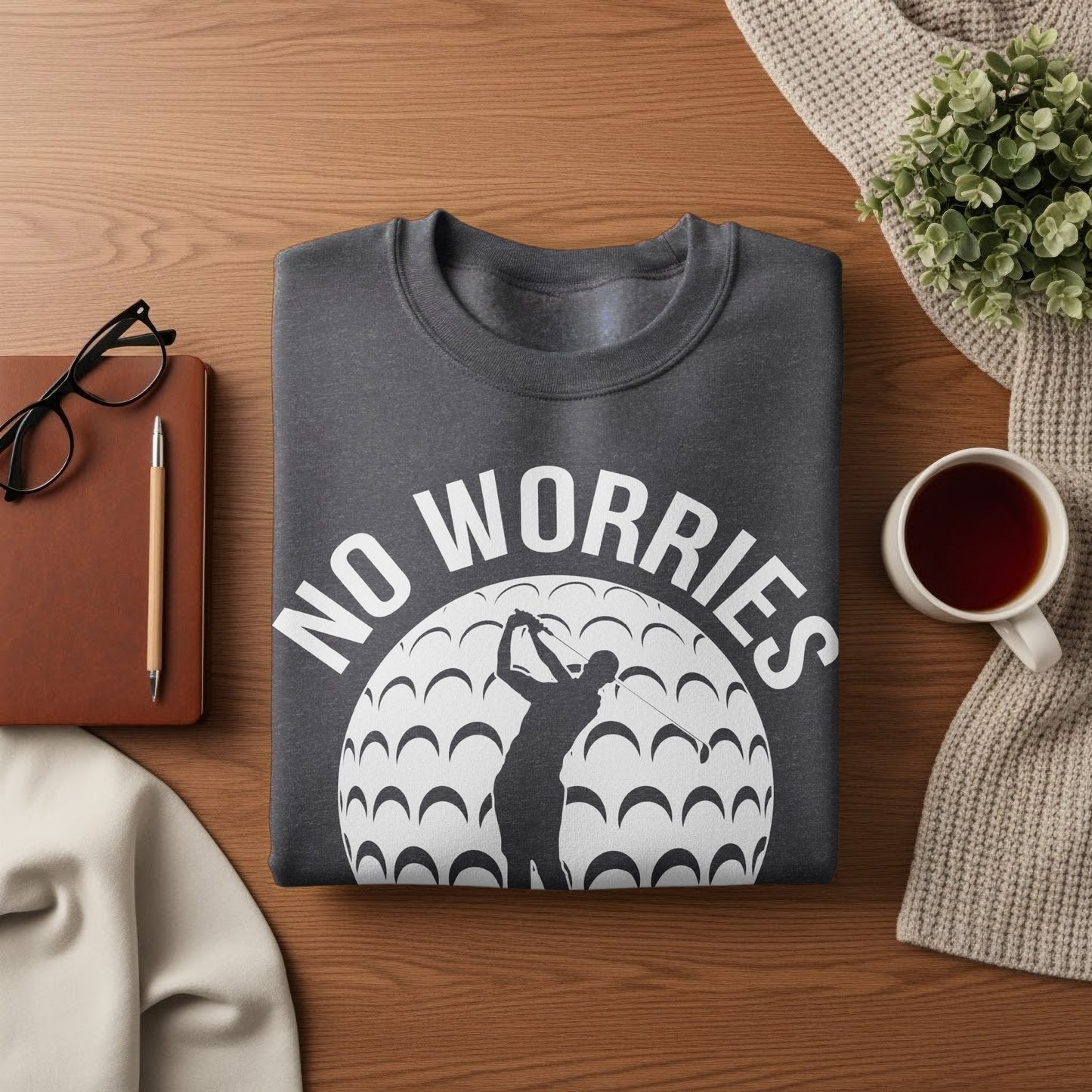 Dark gray sweatshirt with "NO WORRIES" text and golfer silhouette on a golf ball.