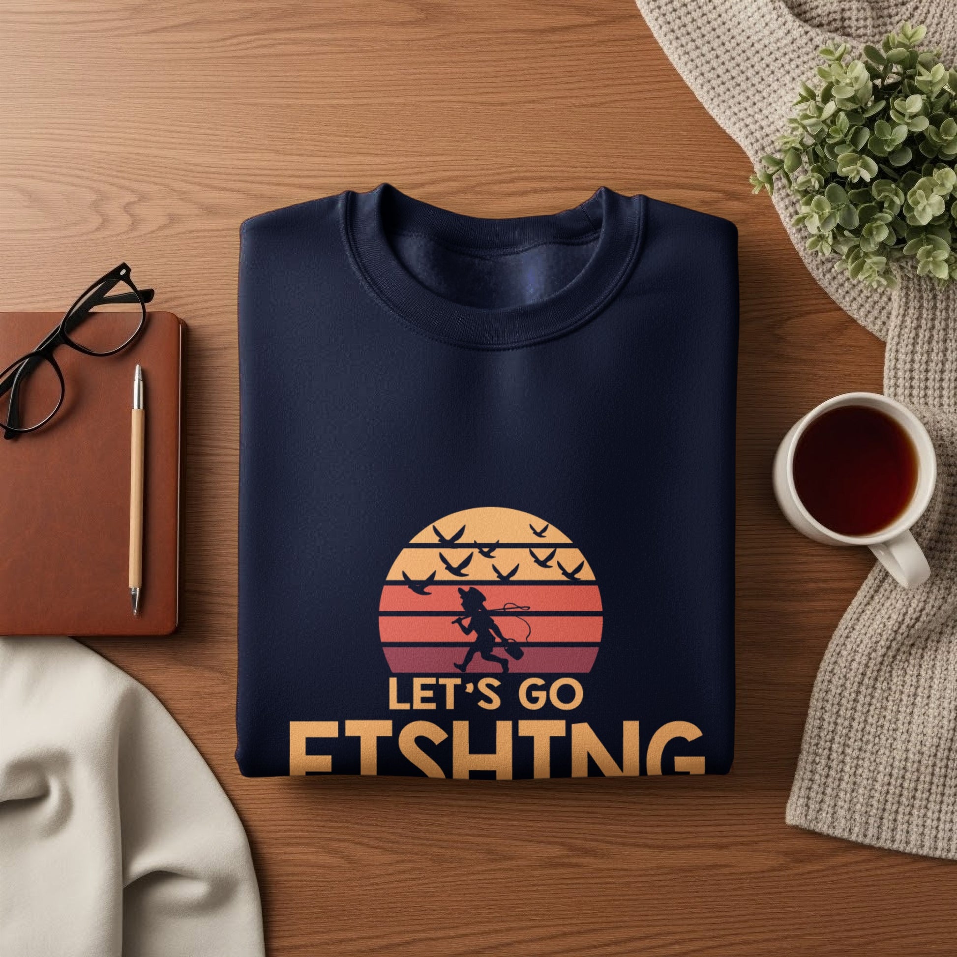 Navy sweatshirt with "Let's Go Fishing" text and birds in sunset graphic.