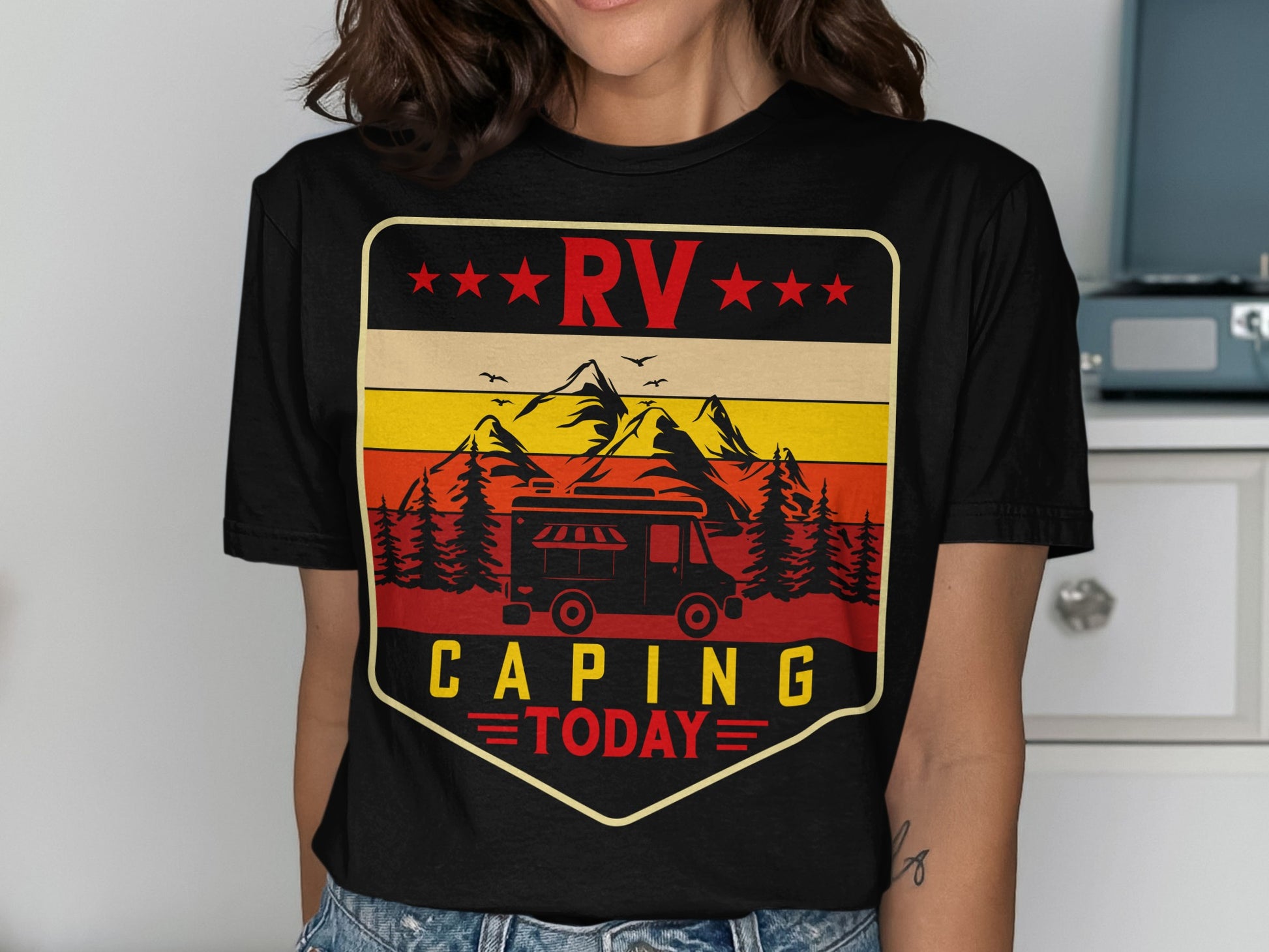 Black t-shirt with RV camping graphic featuring mountains, trees, and vintage camper.