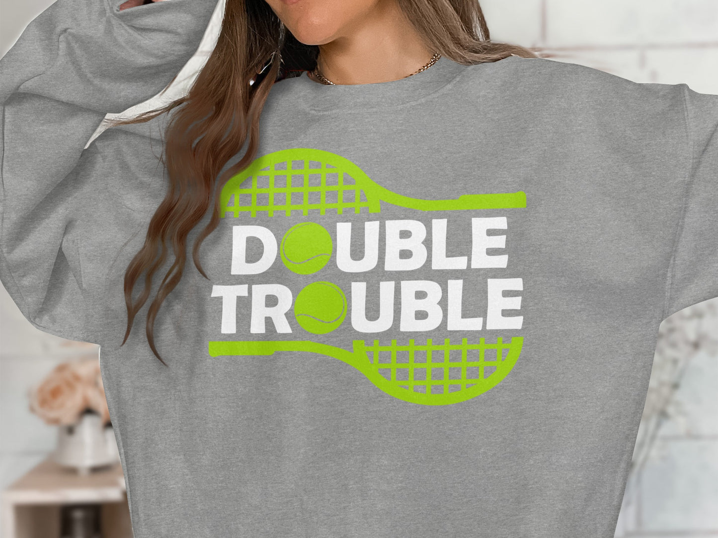 Gray sweatshirt with "DOUBLE TROUBLE" text and tennis racket graphic.