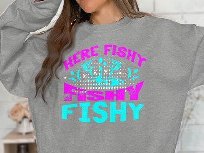 Grey sweatshirt with "WE'RE FISHY FISHY" text in teal and pink.