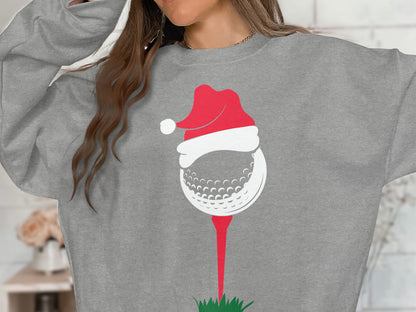 Gray sweatshirt with a graphic of a golf ball wearing a Santa hat.